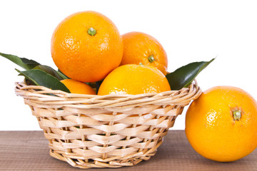 basket of oranges on wooden board