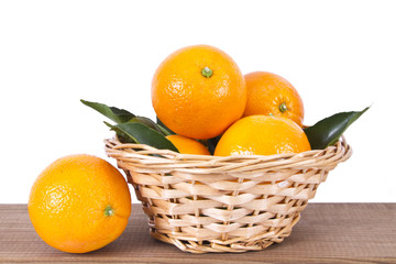 basket of oranges on wooden board