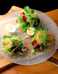 Fine dining mixed salad with ruccola, pine nuts, eggs