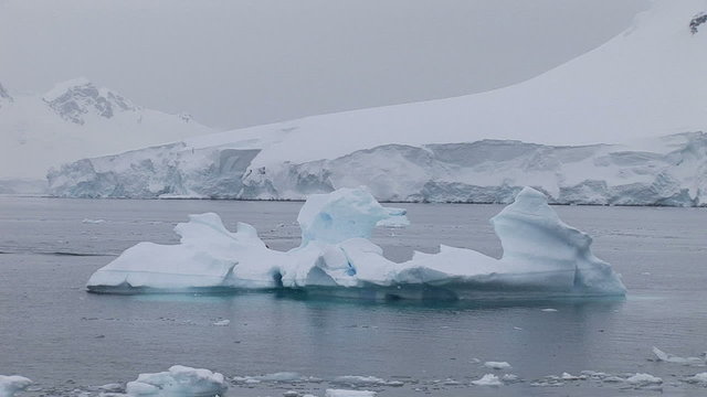 Icebergs and zodiac in the water, Paradise Harbour, Antarctica