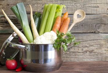 Fresh vegetables in the pot on vintage boards cooking concept