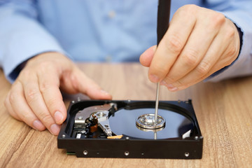 Engineer is recovering lost data from failed hard disk drive