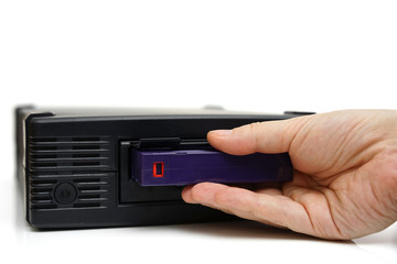 system administrator inserting a backup tape in a backup unit