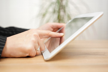 Woman is  working on tablet computer