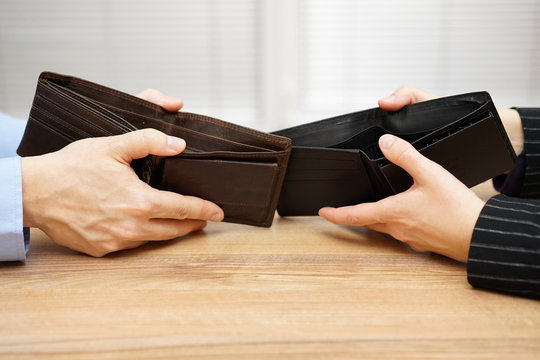man and woman shows empty wallet to each other