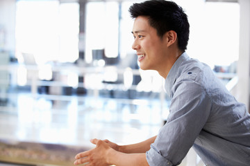 Portrait of young man in office smiling