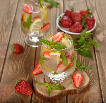 Cold drink with strawberries, lemon and mint