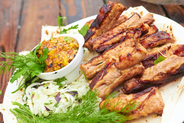 grilled ribs on fire with vegetables