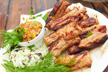 grilled ribs on fire with vegetables