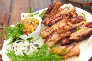 grilled ribs on fire with vegetables