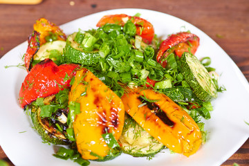 dish with grilled sweet peppers, zucchini, green onions and herb