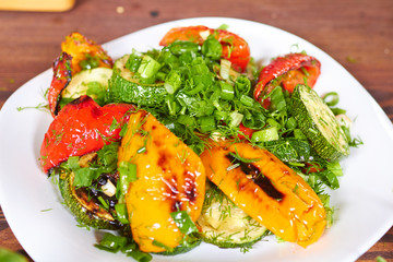 dish with grilled sweet peppers, zucchini, green onions and herb