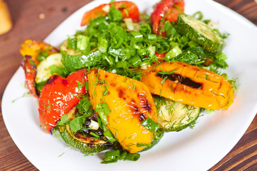 dish with grilled sweet peppers, zucchini, green onions and herb