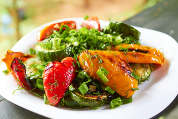 dish with grilled sweet peppers, zucchini, green onions and herb