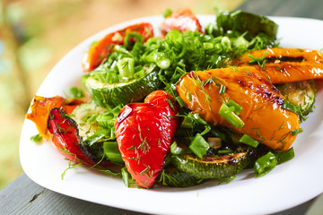 dish with grilled sweet peppers, zucchini, green onions and herb