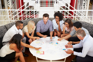Group of work colleagues having meeting in an office lobby