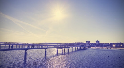 Fototapeta premium Vintage toned pier against sun, Heringsdorf, Germany.