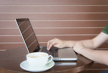 Close up woman hands working with laptop