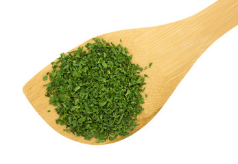 Wood spoon with portion of parsley flakes