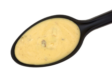 Black spoon full of mushroom soup