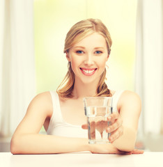 young smiling woman with glass of water