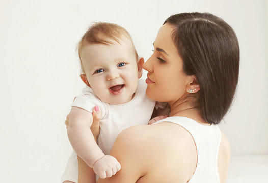 Closeup portrait of happy baby with mother at home