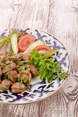 Fried meat with onion in a frying pan