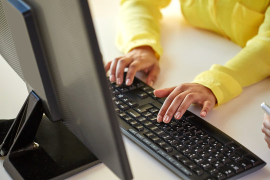close up of female hands with computer typing