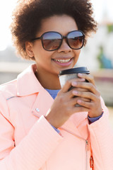 smiling african american woman drinking coffee