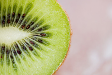 Fototapeta na wymiar close up of ripe kiwi slice on table