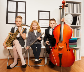 Happy group of kids playing musical instruments