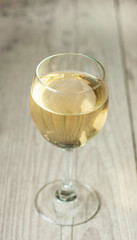 white wine in glass on vintage background