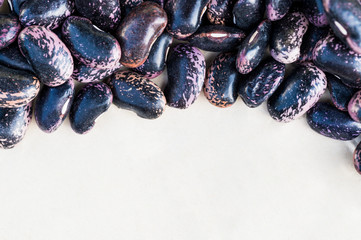 Purple beans on white background close up