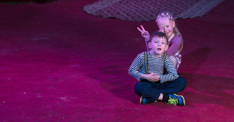 Boy and Girl Seated Together on Stage