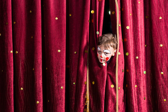 Impatient Young Actor Peeking Out From The Curtain