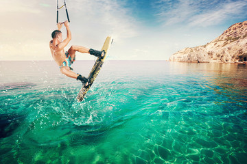 Wakeboarder making tricks on the sea. Wakeboarding. Water sports