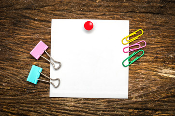 Paper note with clip on wooden table