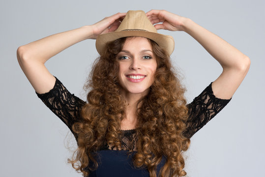 Beautiful young woman wearing hat and smiling at camera