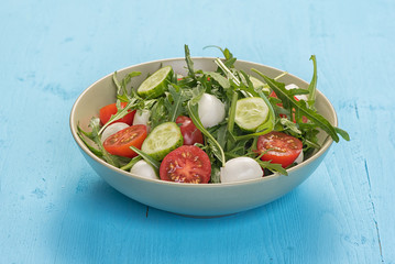 fresh vegetable salad with mozzarella and arugula