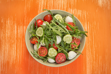 fresh vegetable salad with mozzarella and arugula