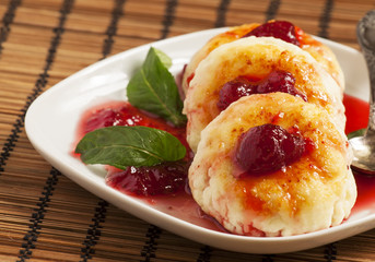 Homemade cottage cheese pancakes with strawberry jam, selective