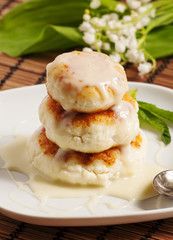 Homemade cottage cheese pancakes with white sauce, selective foc