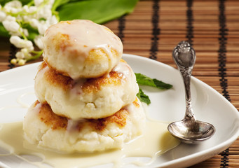 Homemade cottage cheese pancakes with white sauce, selective foc