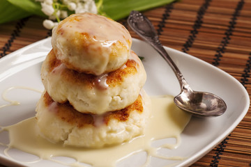 Homemade cottage cheese pancakes with white sauce, selective foc