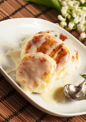 Homemade cottage cheese pancakes with white sauce, selective foc