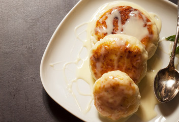 Homemade cottage cheese pancakes with white sauce, selective foc