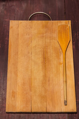 cutting Board and kitchen spatula on the wooden background