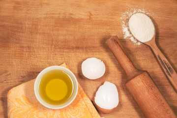 homemade baking. Kitchen rolling pin, a spoon flour, shell of the egg, sunflower oil, towel chopping Board