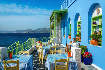 Typical colorful Greek restaurant, Kalymnos, Dodecanese Islands, - obrazy, fototapety, plakaty