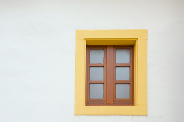 Fototapeta na wymiar old colorful window in a white exterior wall